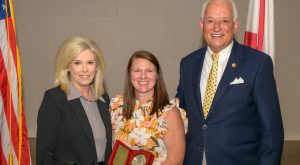 Kristen Shipman receives Troy University's Vergil Parks McKinley Award from Alicia Bookout and TROY Chancellor Dr. Jack Hawkins, Jr. 